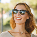 The ELLIPSE All Black features a characteristic rounded black frame with black lenses. Composed of durable Italian Mazzucchelli bio-acetate with hand-finished natural rosewood temples and black acetate tips. Bio-acetate is made from cotton and organic res