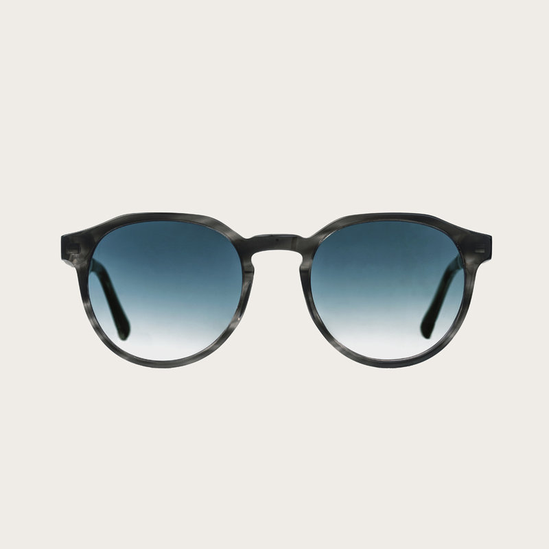 The REVELER Heritage Gradient Blue features a sleek geometric grey tortoise frame with gradient blue lenses. Composed of durable Italian Mazzucchelli bio-acetate with hand-finished natural zebrawood temples and tortoise acetate tips. Bio-acetate is made f